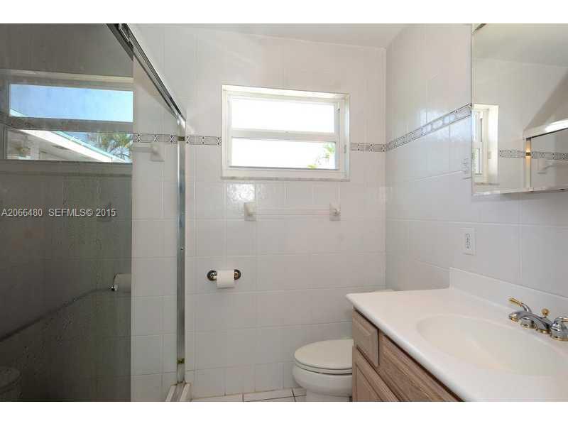 5010 West Park Road Hollywood, FL 33021 - Photo 9 of 16 a bathroom with a sink a toilet and a mirror