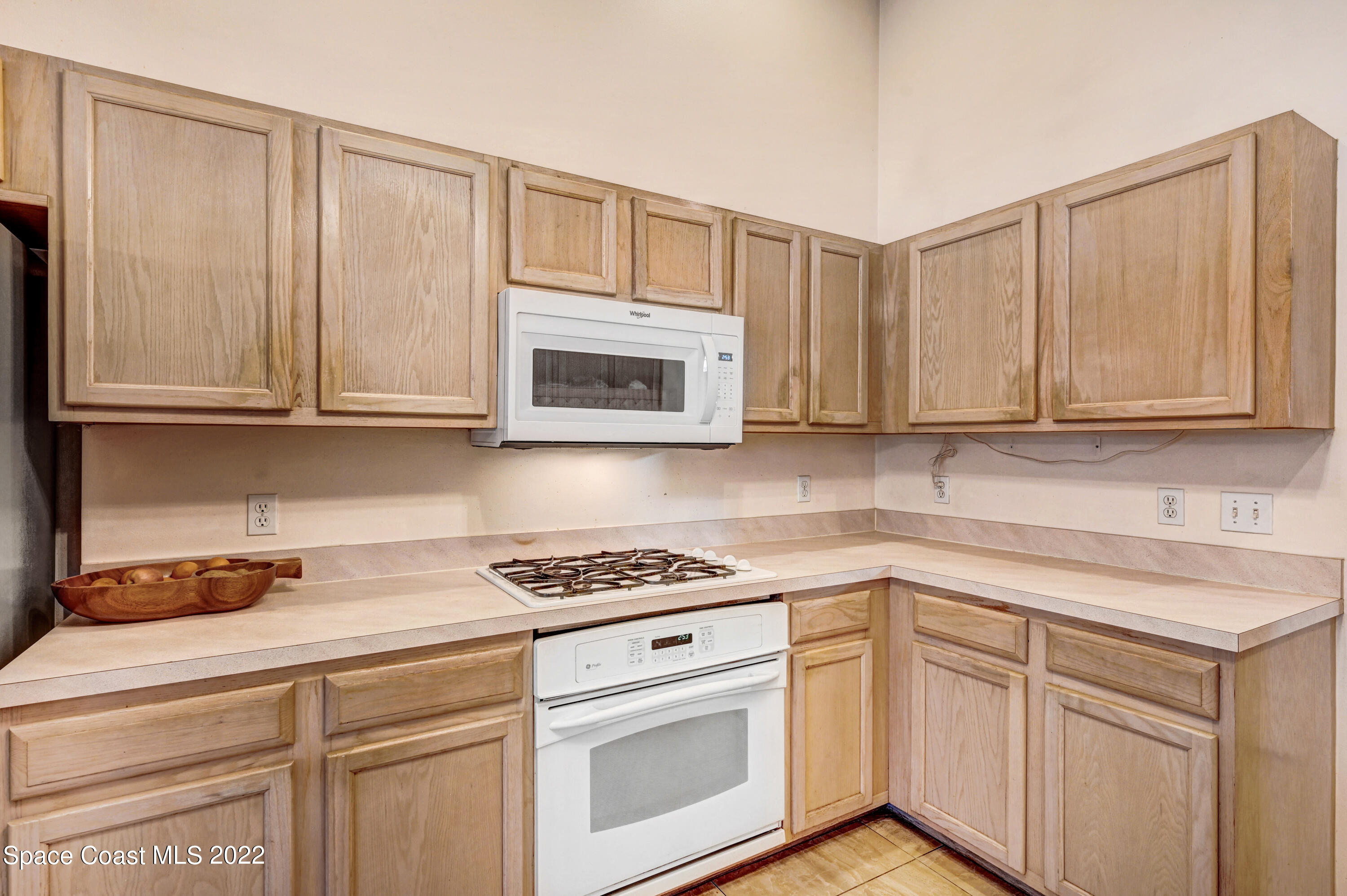 1924 Glen Meadows Circle Melbourne, FL 32935 - Photo 11 of 27 a kitchen with white cabinets and white appliances