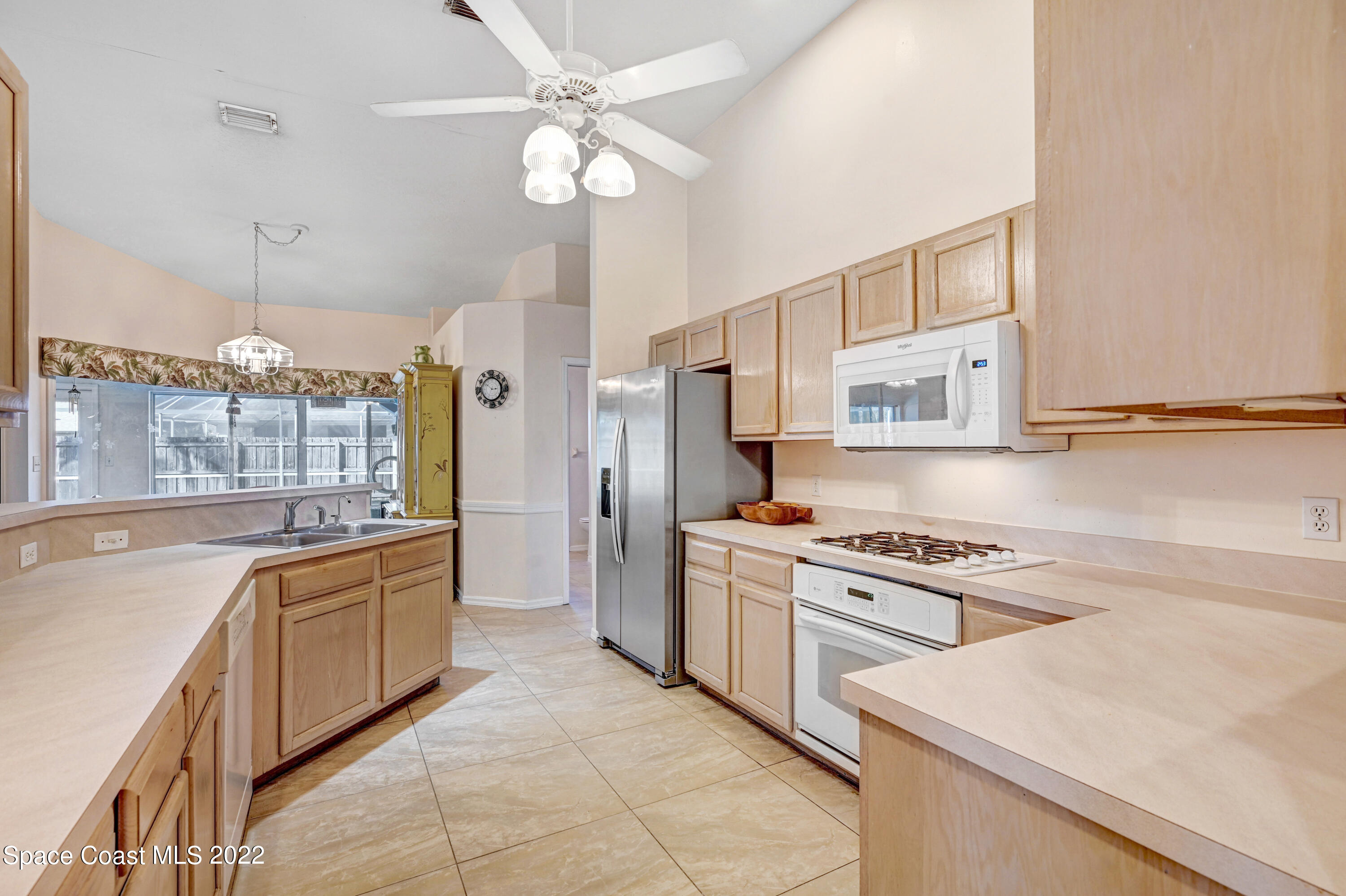 1924 Glen Meadows Circle Melbourne, FL 32935 - Photo 12 of 27 a kitchen with stainless steel appliances granite countertop a stove a sink dishwasher and a refrigerator