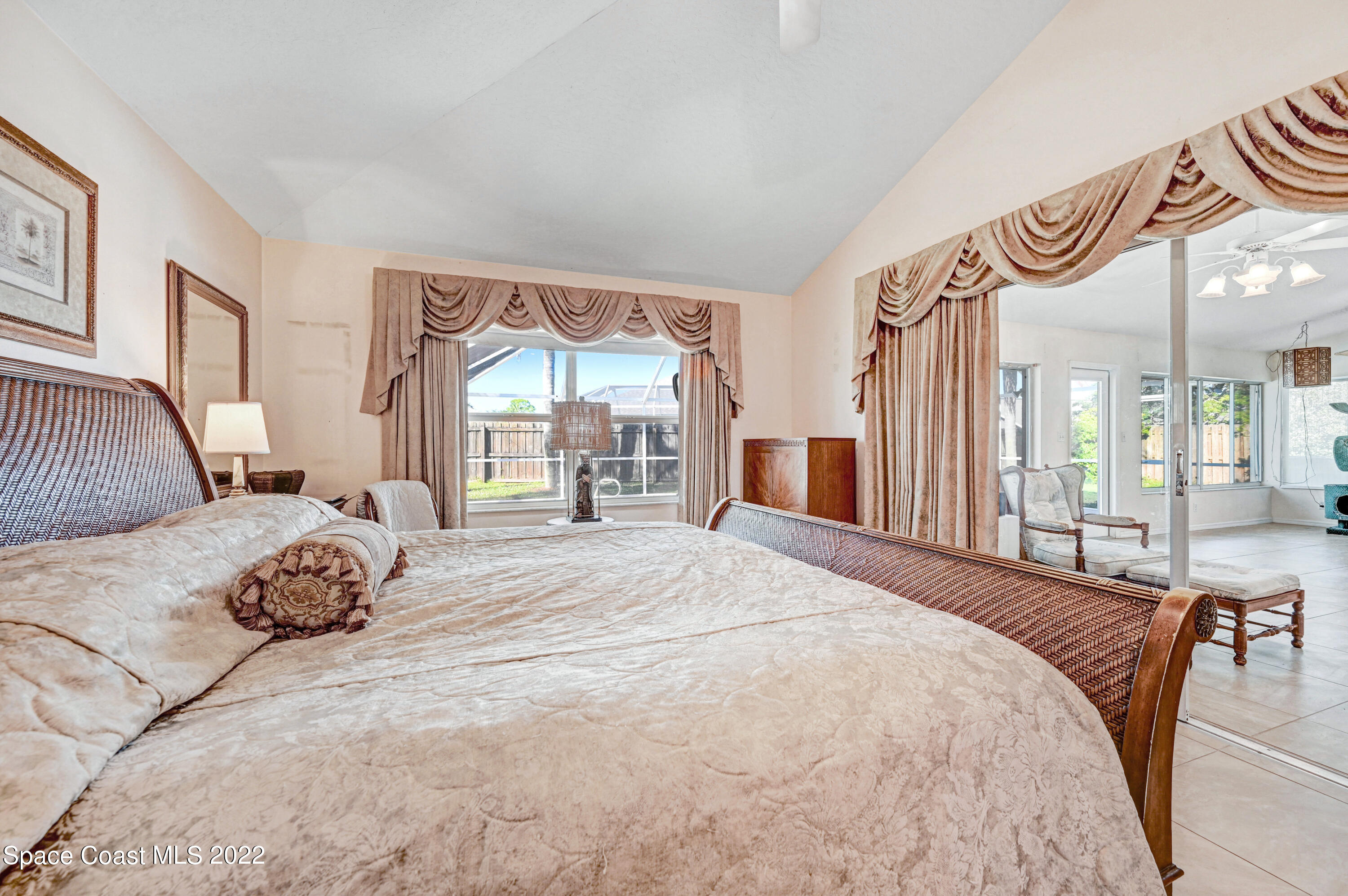 1924 Glen Meadows Circle Melbourne, FL 32935 - Photo 14 of 27 a bedroom with a bed and glass windows