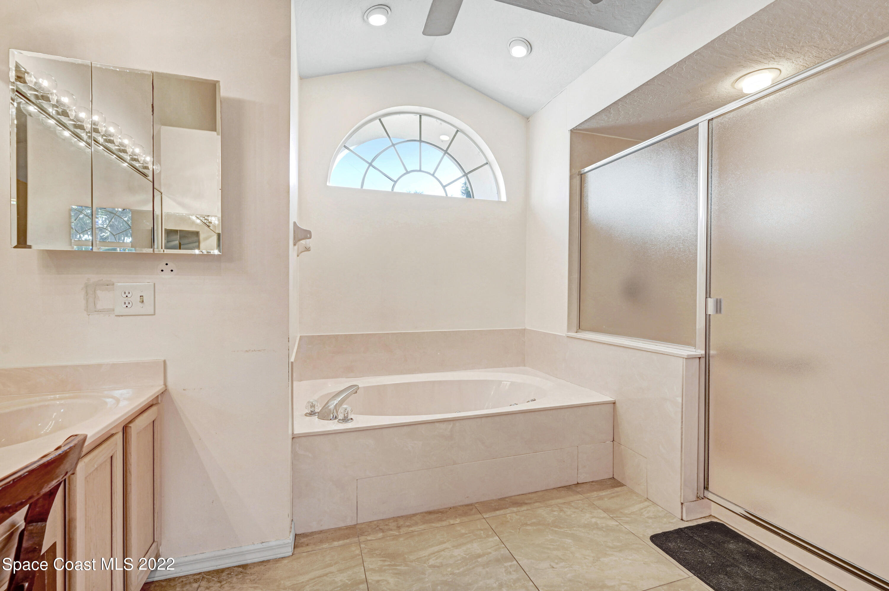 1924 Glen Meadows Circle Melbourne, FL 32935 - Photo 17 of 27 a bathroom with a bathtub and a shower