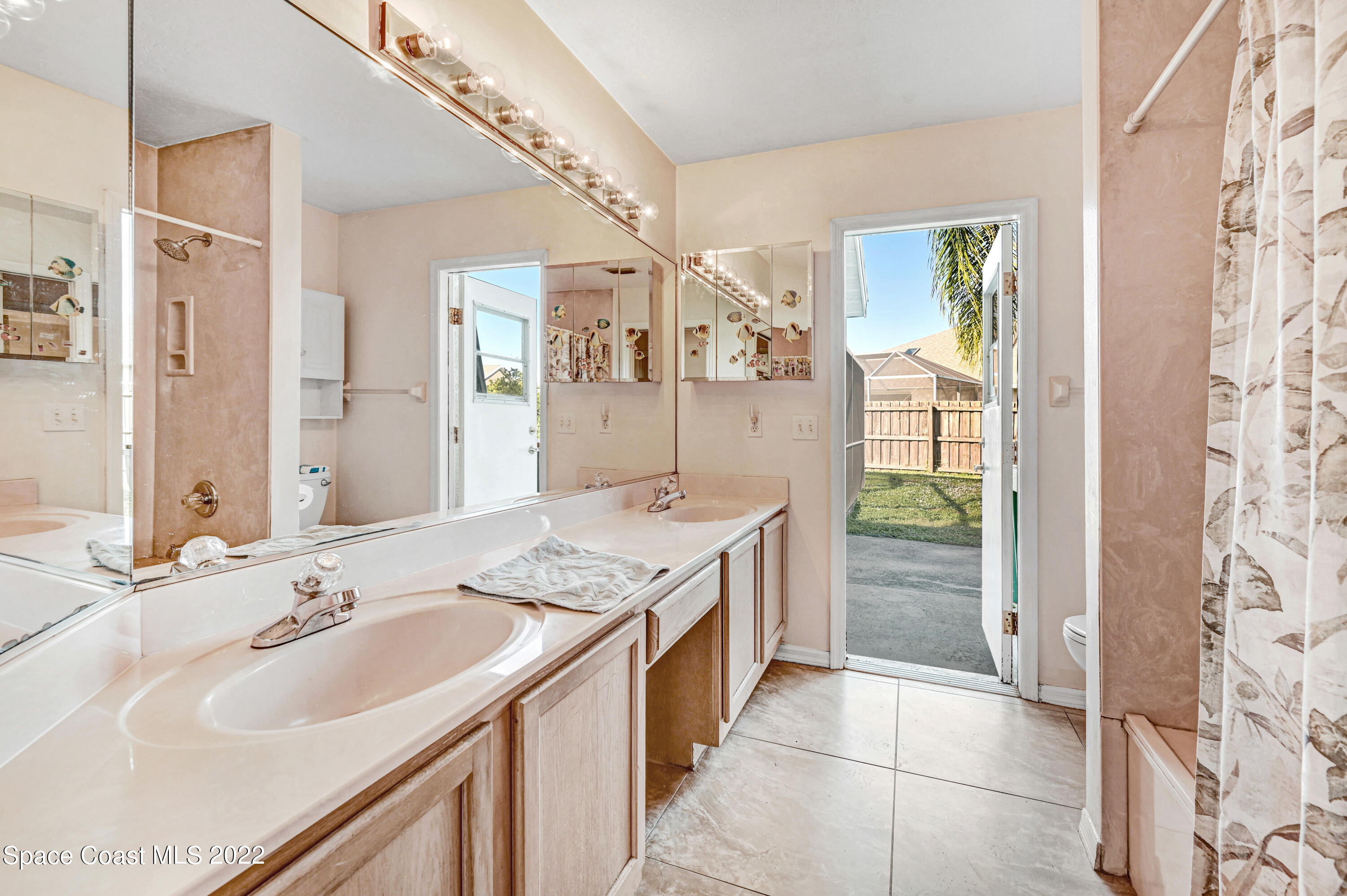1924 Glen Meadows Circle Melbourne, FL 32935 - Photo 20 of 27 a spacious bathroom with a granite countertop sink mirror and shower