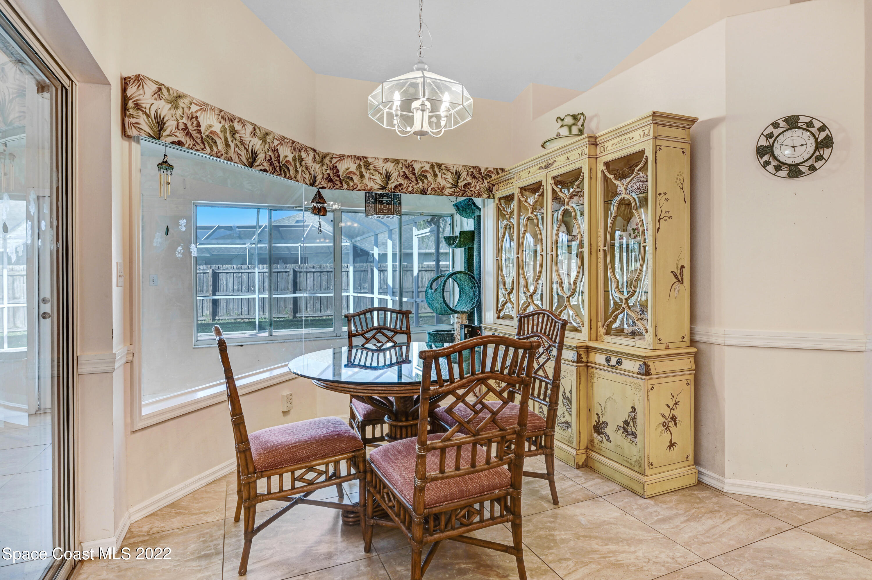 1924 Glen Meadows Circle Melbourne, FL 32935 - Photo 5 of 27 a view of a dining room with furniture and a chandelier