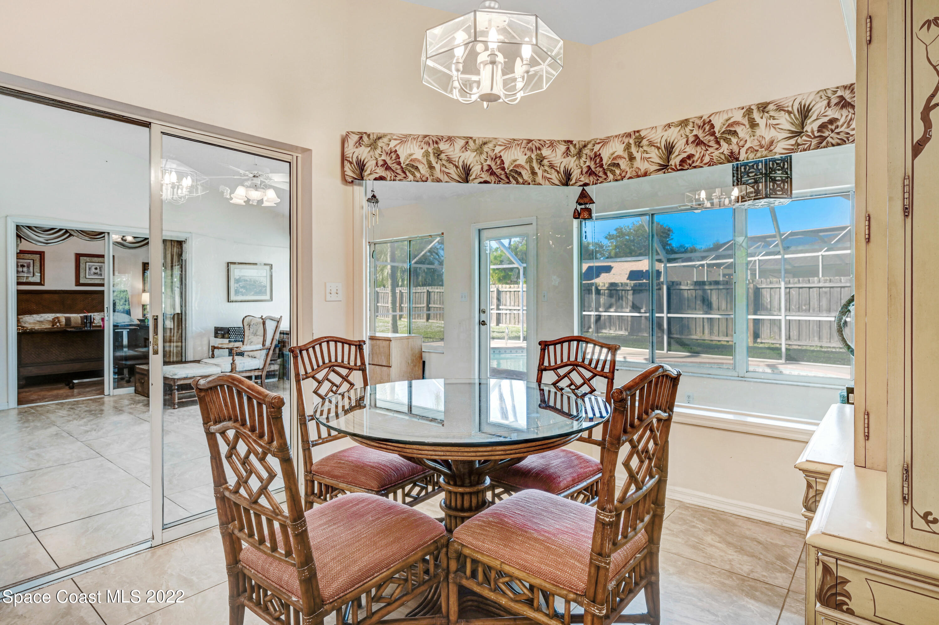 1924 Glen Meadows Circle Melbourne, FL 32935 - Photo 8 of 27 a dining room with furniture a chandelier and wooden floor