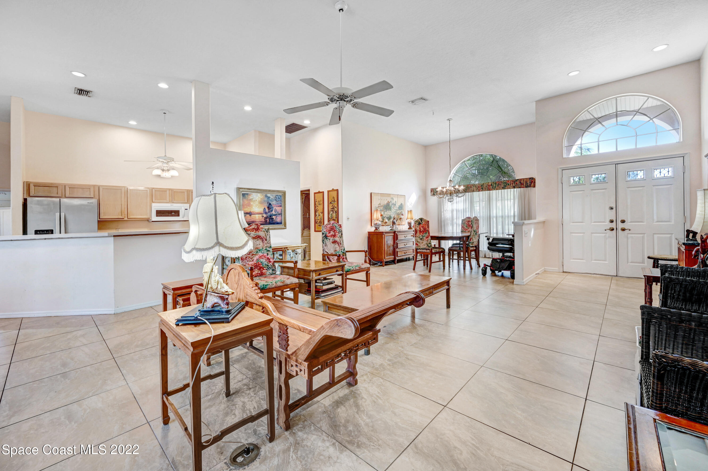 1924 Glen Meadows Circle Melbourne, FL 32935 - Photo 9 of 27 a living room with lots of furniture and view of kitchen