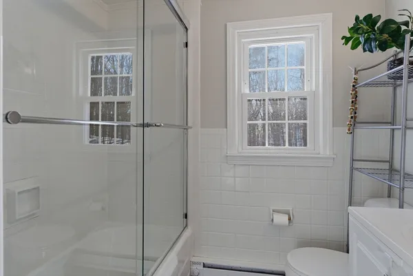 a bathroom with a toilet sink and mirror