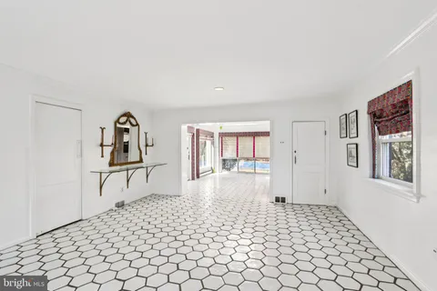 a large bedroom with a large bed and glass door