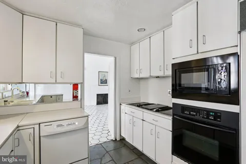 a kitchen with a sink and refrigerator