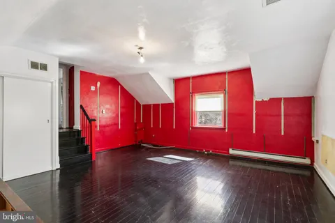 a view of room with window and wooden floor