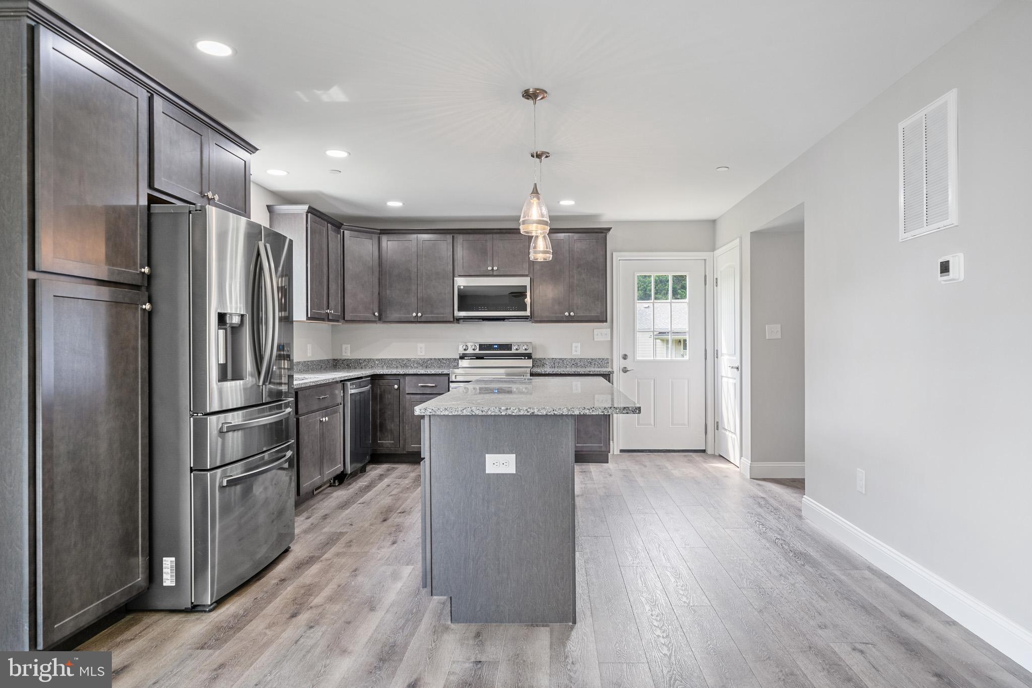 24215 Thistle Place Chaptico, MD 20621 - Photo 13 of 40 a kitchen with a refrigerator a sink and dishwasher