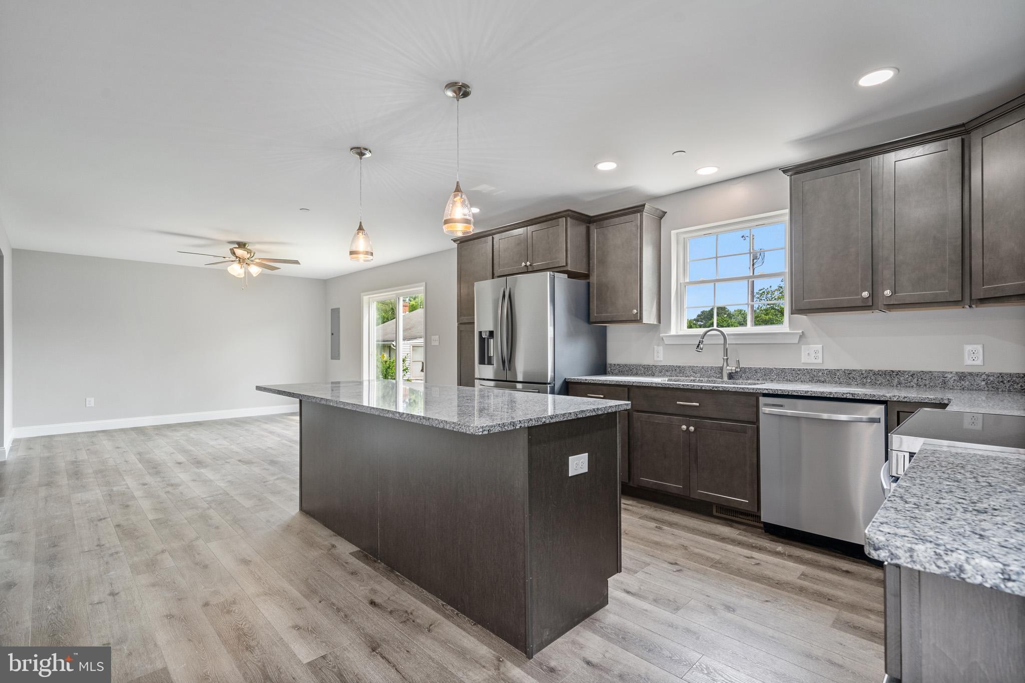 24215 Thistle Place Chaptico, MD 20621 - Photo 14 of 40 a kitchen with stainless steel appliances granite countertop a sink a stove top oven a counter space and cabinets