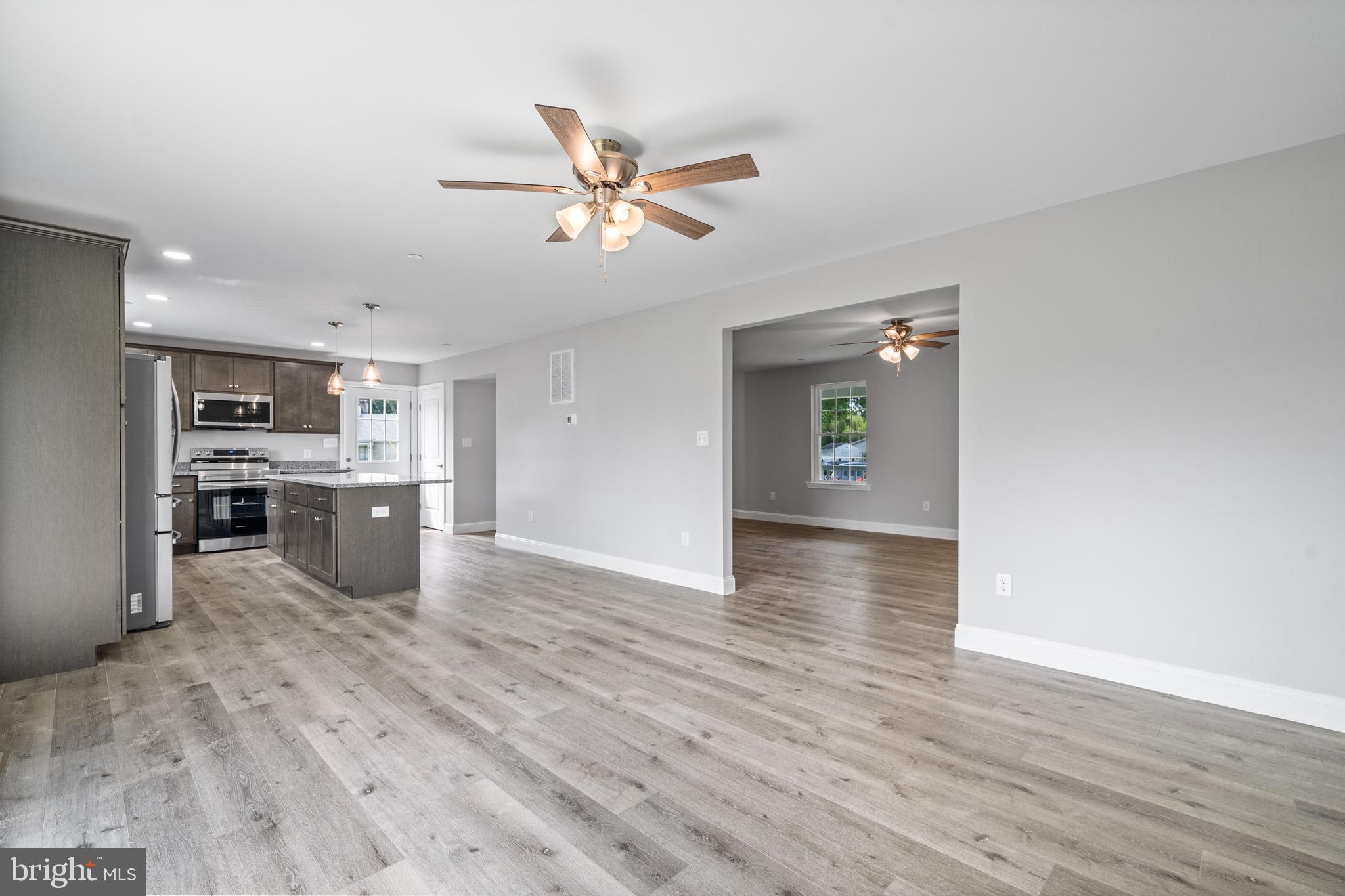 24215 Thistle Place Chaptico, MD 20621 - Photo 15 of 40 a view of a kitchen with a sink dishwasher cabinets and wooden floor