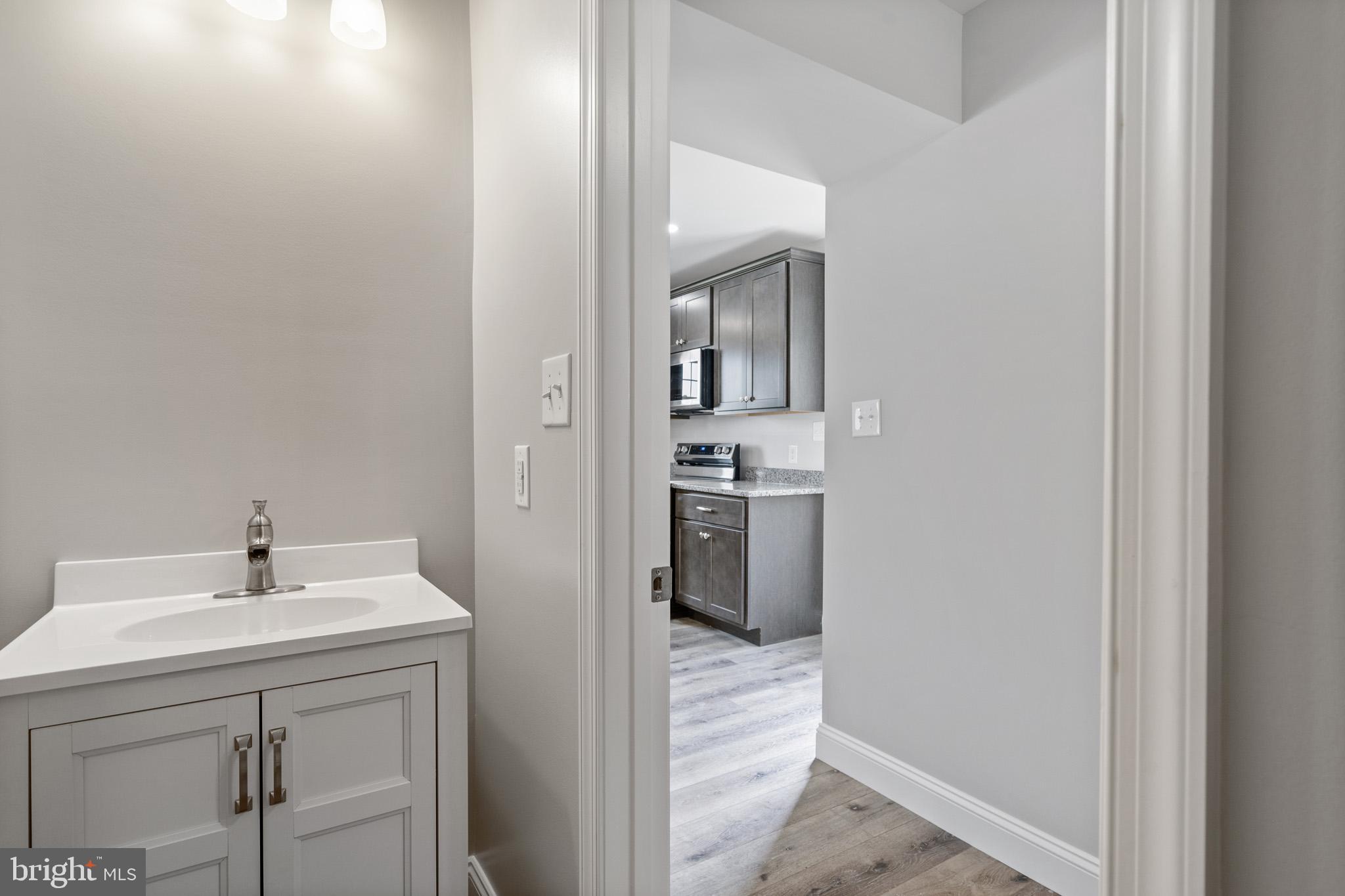 24215 Thistle Place Chaptico, MD 20621 - Photo 17 of 40 a en suite bathroom with a sink and a mirror