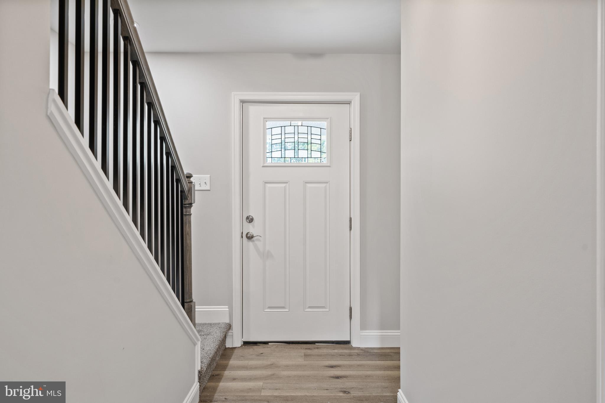 24215 Thistle Place Chaptico, MD 20621 - Photo 3 of 40 a view of a hallway with wooden floor and entryway