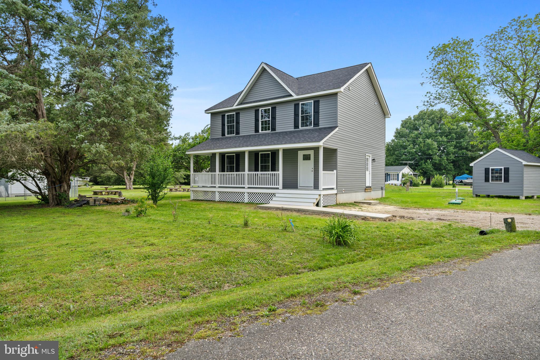 24215 Thistle Place Chaptico, MD 20621 - Photo 33 of 40 a front view of a house with swimming pool and porch
