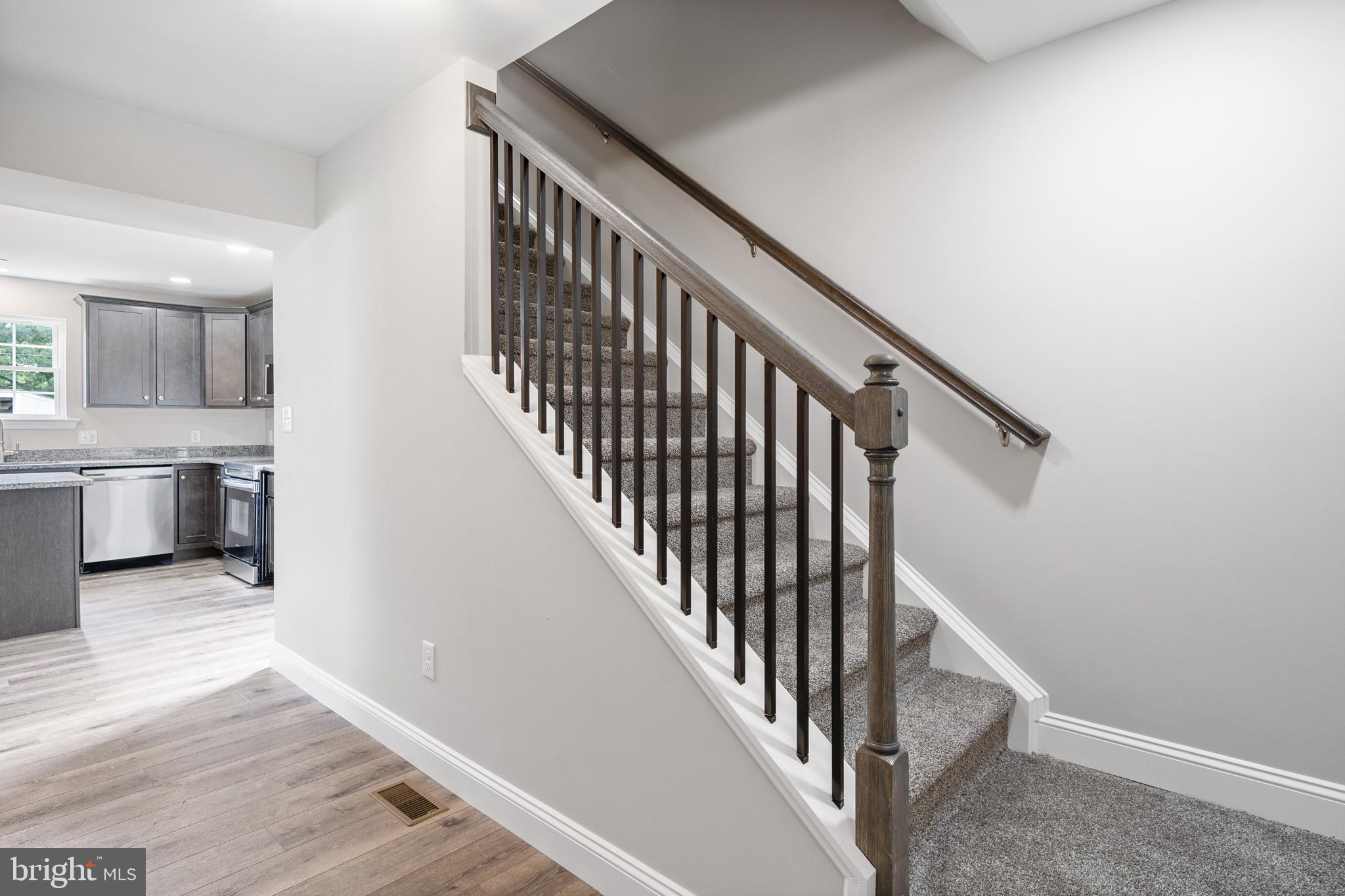 24215 Thistle Place Chaptico, MD 20621 - Photo 4 of 40 a view of a hallway with the wooden floor and staircase