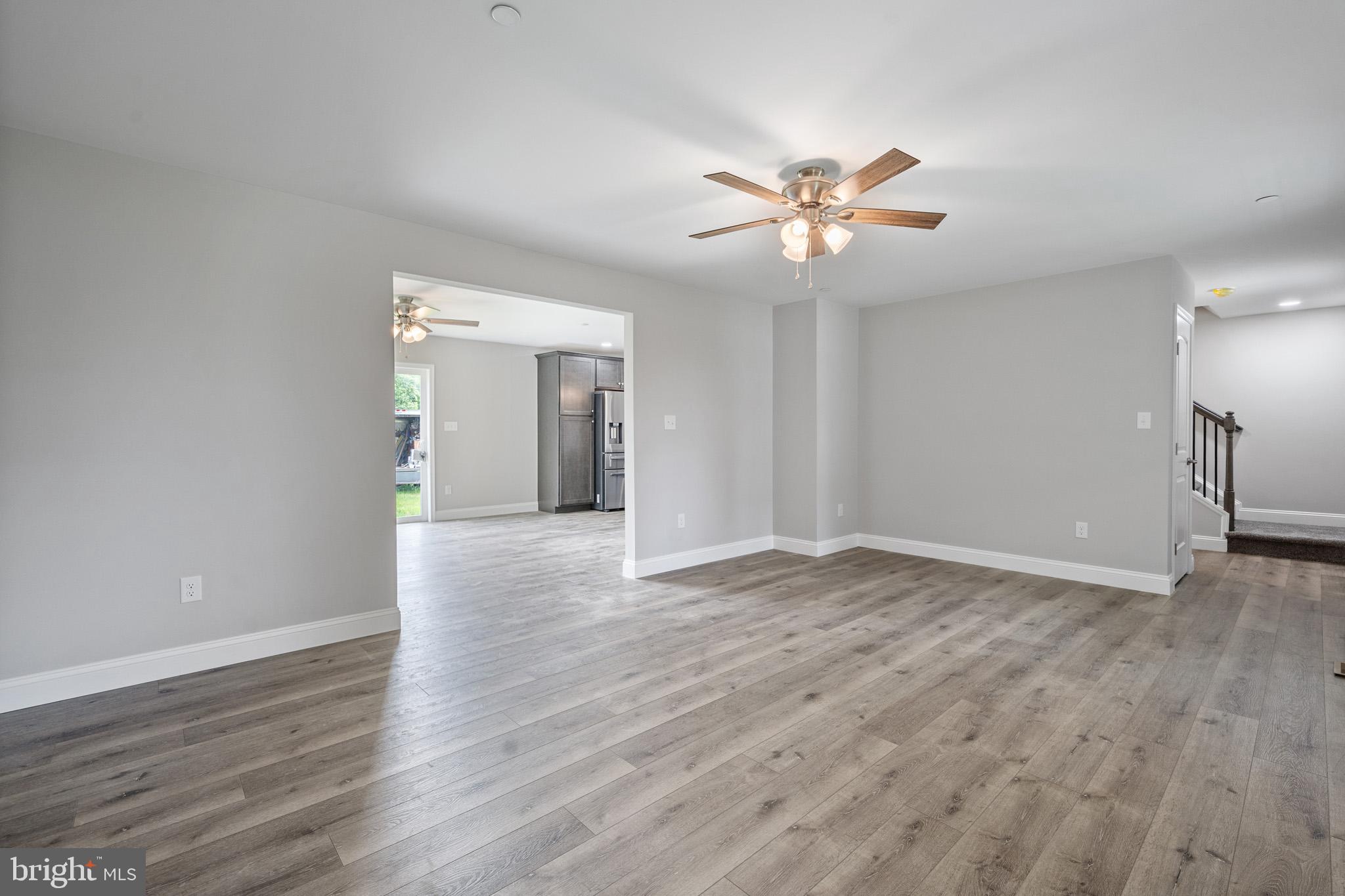 24215 Thistle Place Chaptico, MD 20621 - Photo 5 of 40 a view of an empty room with window and wooden floor