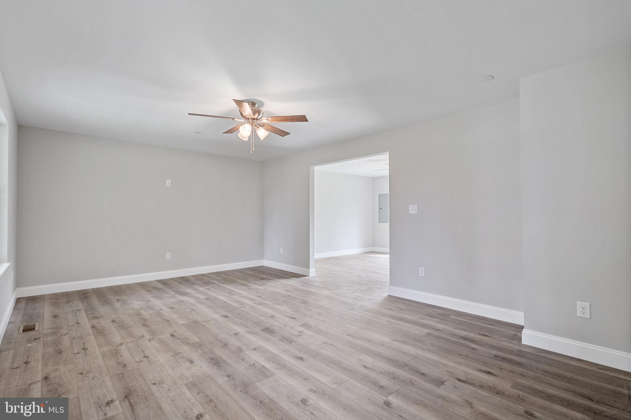 24215 Thistle Place Chaptico, MD 20621 - Photo 6 of 40 a view of an empty room with wooden floor