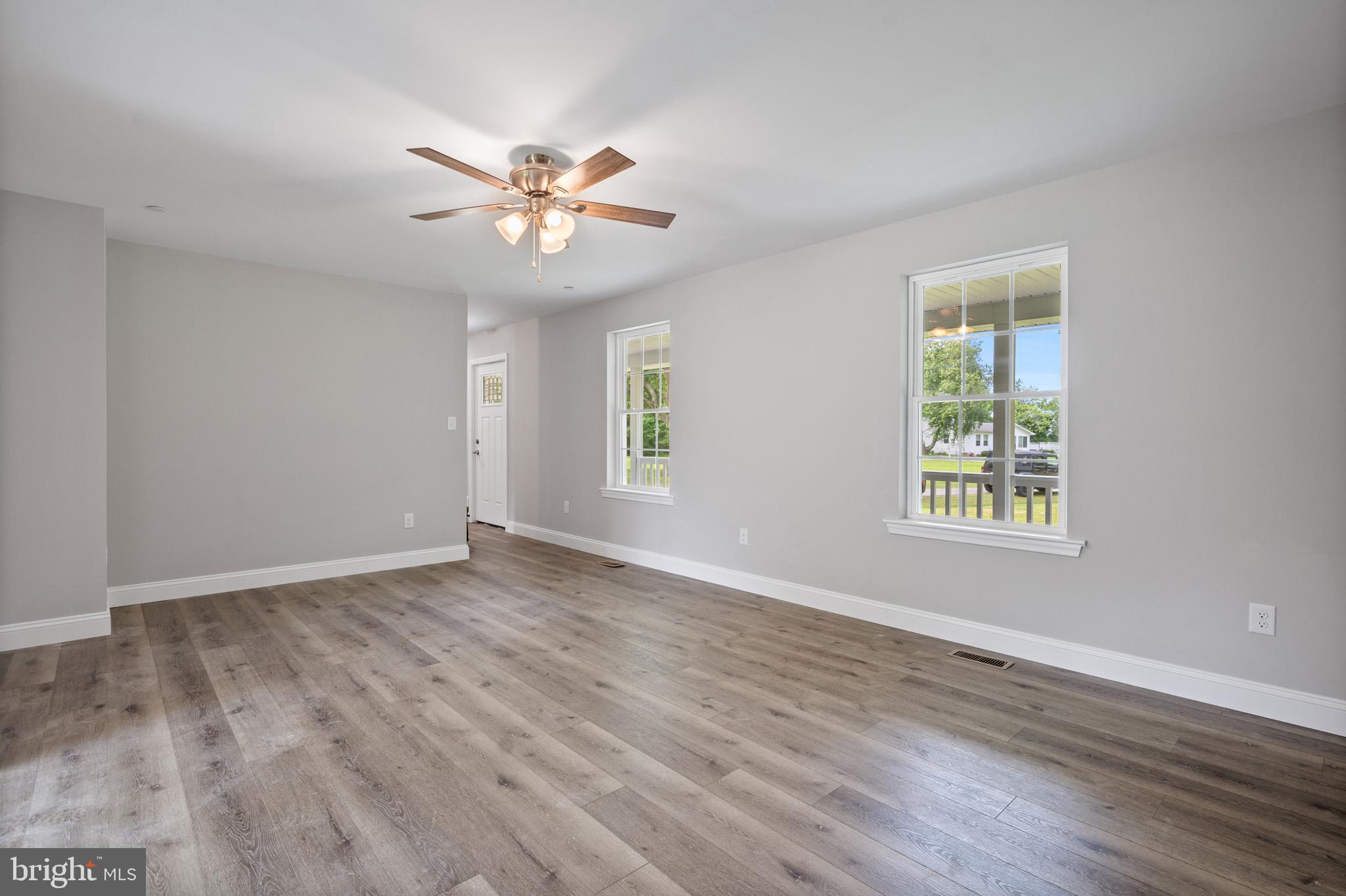 24215 Thistle Place Chaptico, MD 20621 - Photo 7 of 40 a view of an empty room with wooden floor and a window