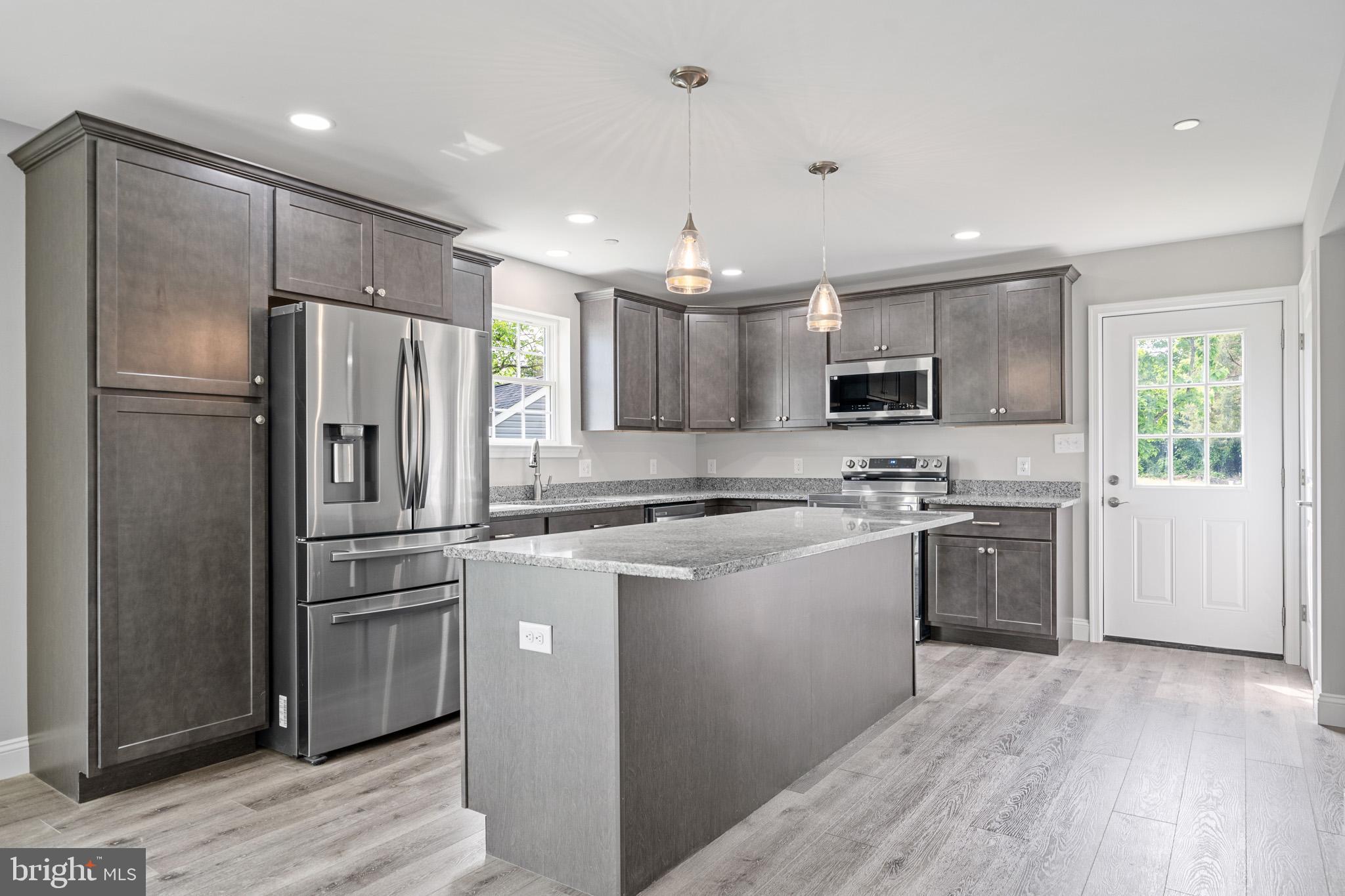 24215 Thistle Place Chaptico, MD 20621 - Photo 8 of 40 a kitchen with a refrigerator a sink and a stove top oven