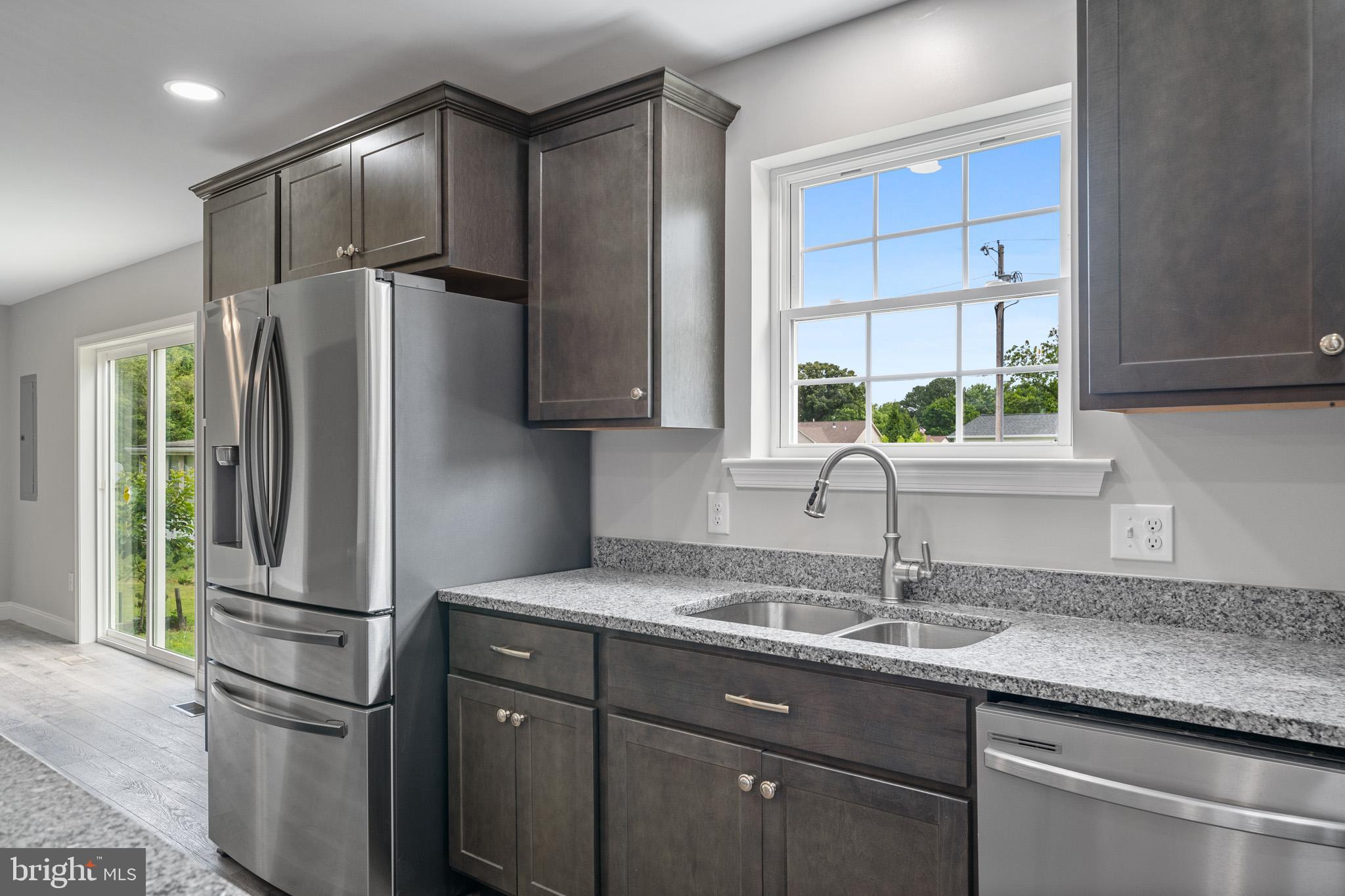 24215 Thistle Place Chaptico, MD 20621 - Photo 9 of 40 a kitchen with stainless steel appliances granite countertop a refrigerator and a sink