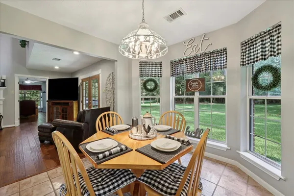 a view of a dining room with furniture wooden floor and chandelier