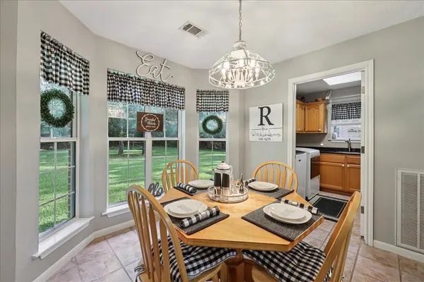 a view of a dining room with furniture wooden floor and chandelier