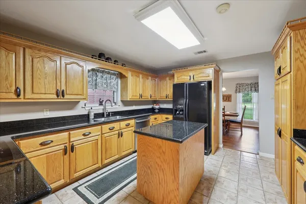 a kitchen with stainless steel appliances granite countertop a sink and cabinets