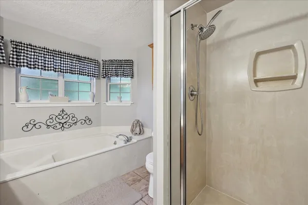 a bathroom with a bathtub and a shower