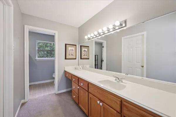 a spacious bathroom with a double vanity sink a mirror and a shower