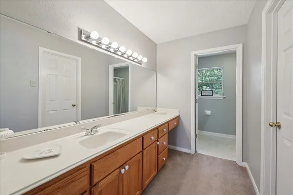 a bathroom with a sink double vanity and a mirror