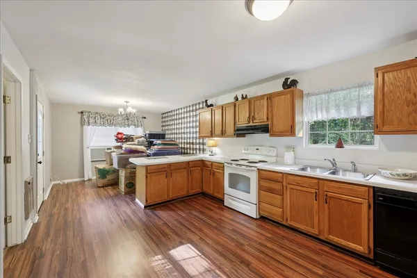 a kitchen with sink cabinets and wooden floor