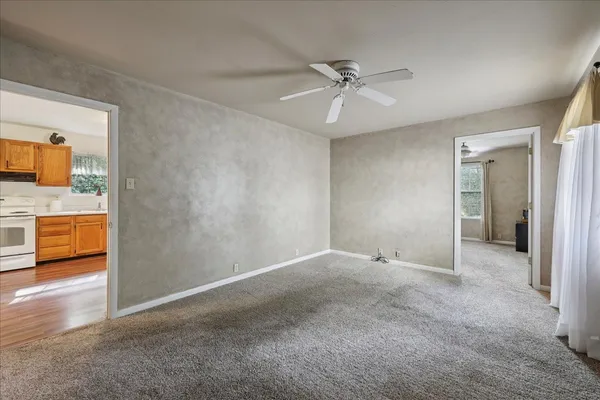 a view of an empty room and a bathroom