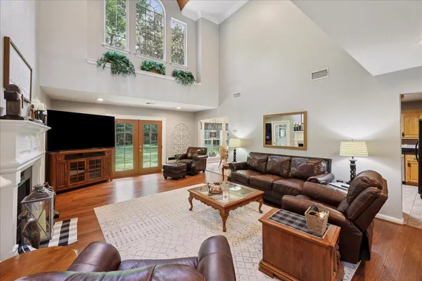 a living room with furniture a flat screen tv and kitchen view