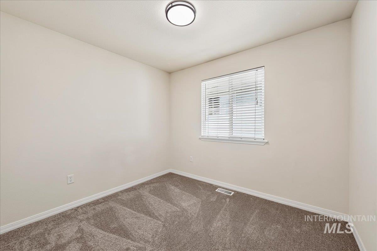 2356 West Hill Road Boise, ID 83702 - Photo 17 of 22 Light-colored walls, window with horizontal blinds, flush mount ceiling light, and carpeted flooring