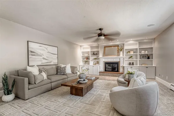 a living room with furniture and a fireplace