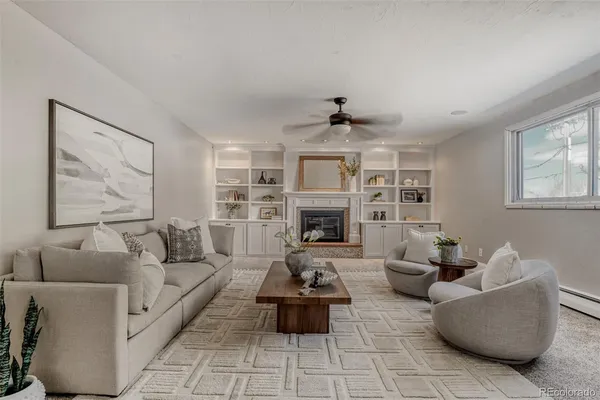 a living room with furniture and a fireplace