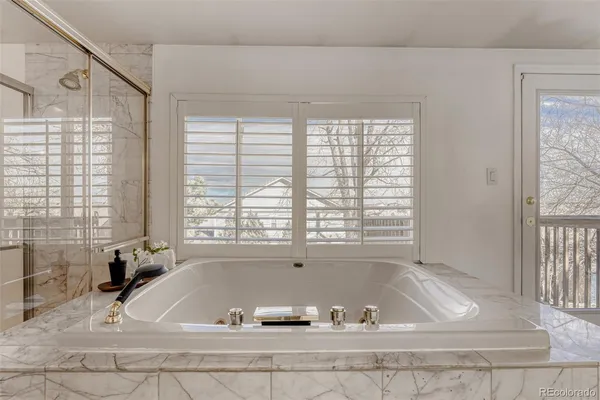 a bath tub sitting in a bathroom next to a window