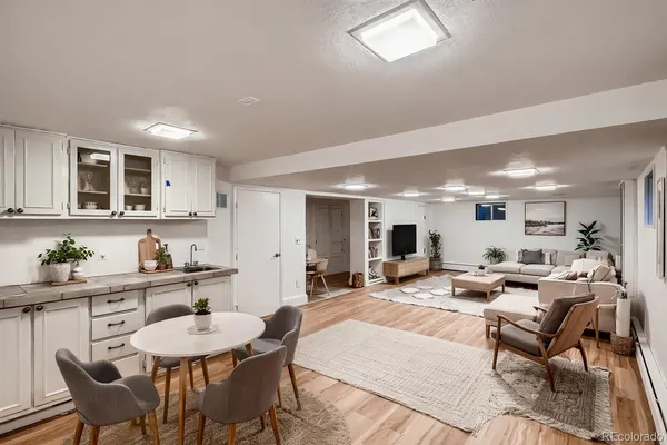 a living room with kitchen island furniture and a wooden floor