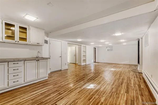 a view of empty room with wooden floor