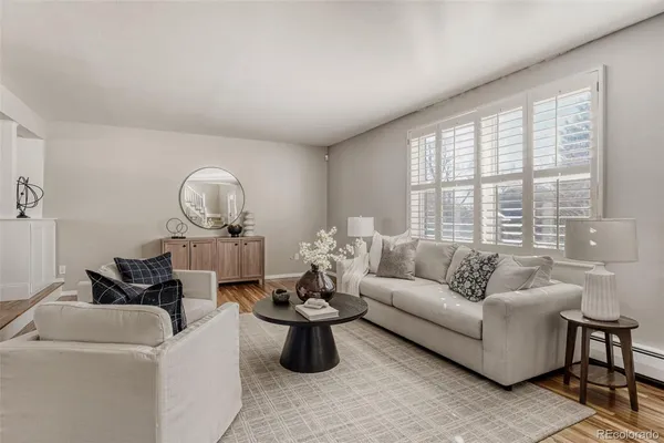 a living room with furniture and wooden floor