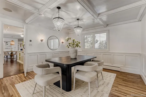 a view of a dining room with furniture and chandelier