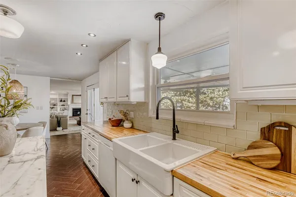 a kitchen with a sink stove and cabinets