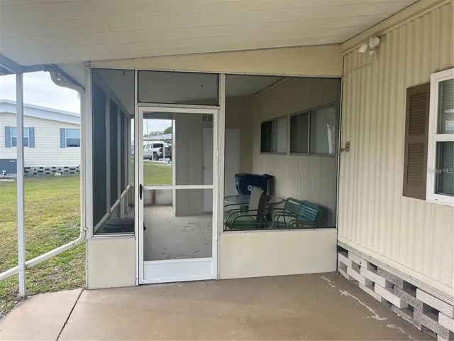 a living room with a couch and chandelier
