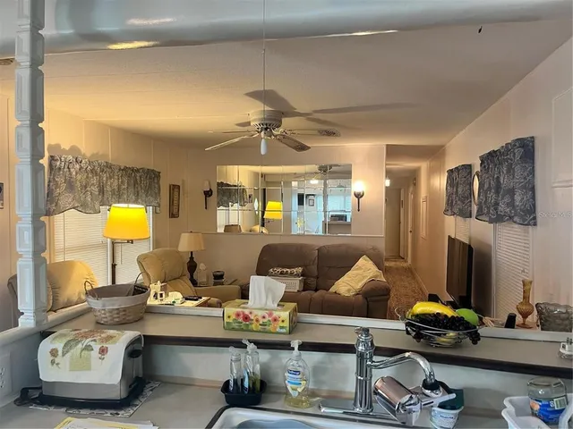 a living room with furniture and a flat screen tv with wooden floor