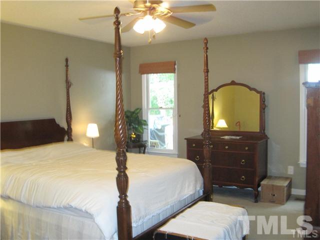 4505 Cobbler Place Raleigh, NC 27613 - Photo 10 of 13 a bedroom with a bed and a dresser