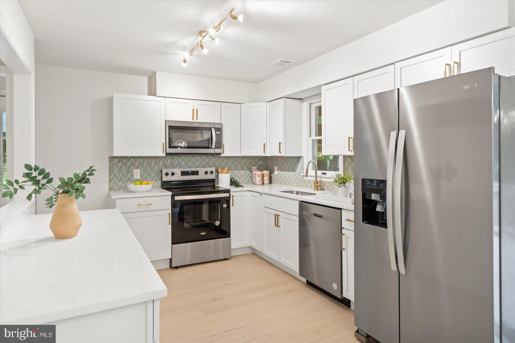4566 Hickory Lane Mount Airy, MD 21771 - Photo 21 of 45 a kitchen with a sink and stainless steel appliances