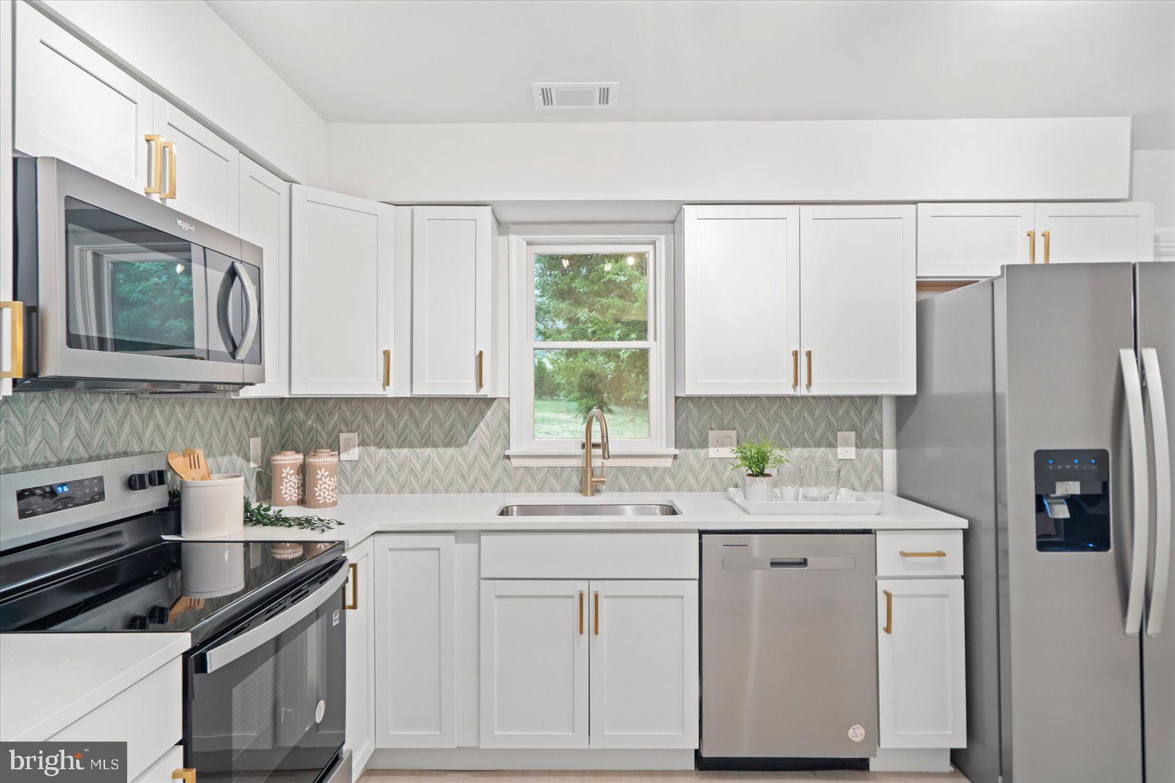 4566 Hickory Lane Mount Airy, MD 21771 - Photo 25 of 45 a kitchen with a sink stove and refrigerator