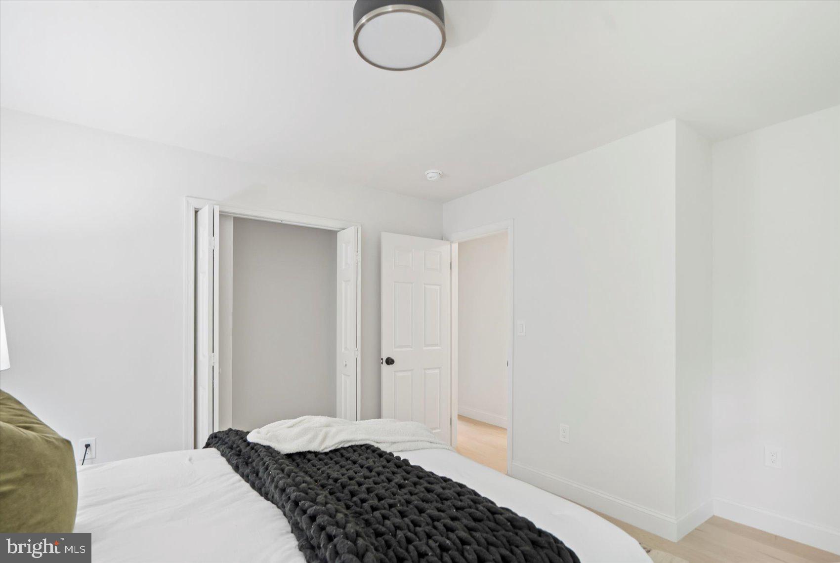 4566 Hickory Lane Mount Airy, MD 21771 - Photo 27 of 45 a bedroom with a bed and a lamp