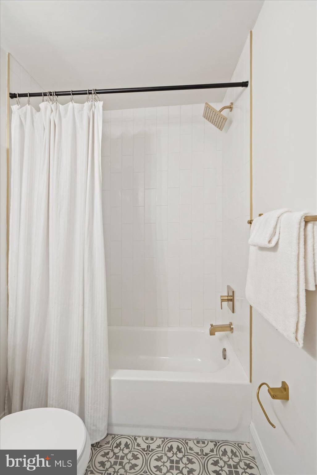 4566 Hickory Lane Mount Airy, MD 21771 - Photo 30 of 45 a bathroom with a shower curtain and a bathtub